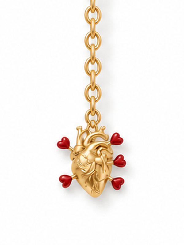Cupid's Heart Gold Necklace – close-up of the gold anatomical heart pendant and red heart arrows